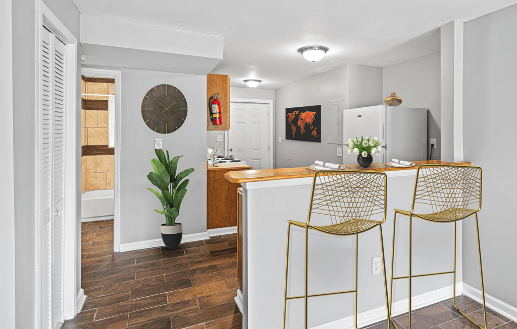 a kitchen with a bar counter at Gardens at Washington Park, Atlanta, GA